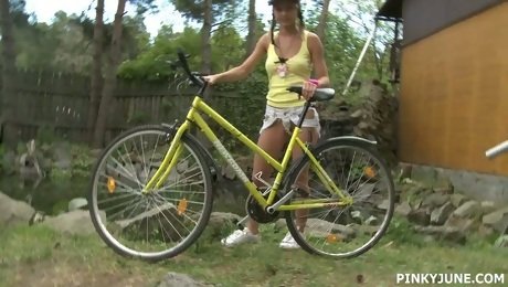 Young blonde is riding her bicycle and masturbating pussy outdoor